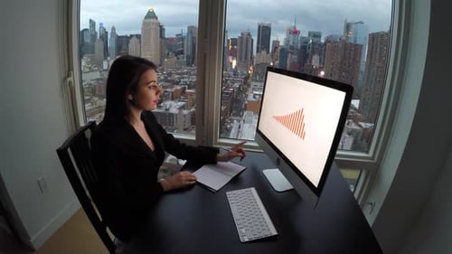 Young Confident Woman Working in Modern Office on Computer Desk At Night