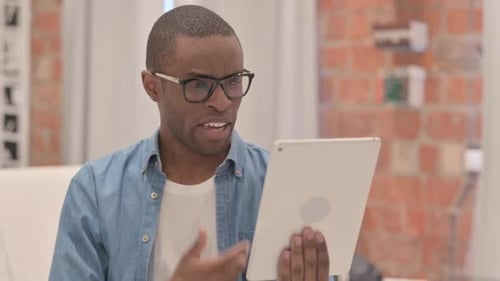 portrait of African Man Doing Video Chat on Tablet