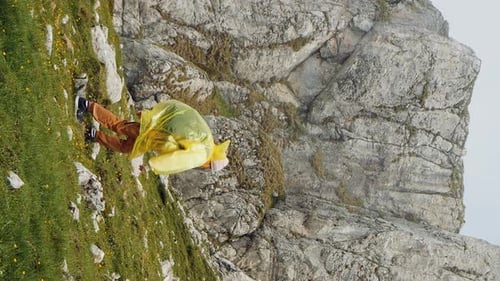 Vertical Screen woman difficult climbing the mount in a rainy misty weather