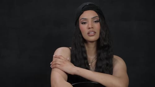 Attractive Woman Posing in Front of Dark Background