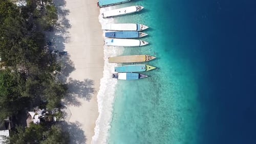 Amazing aerial view of the coastline with moored boats, sunny Bali Indonesia