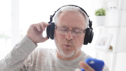 Senior Man Listening to Music with Headphones
