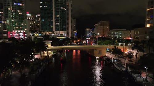 River and bridge in downtown of american city at night. Lighting buildings and skyscrapers of USA. S