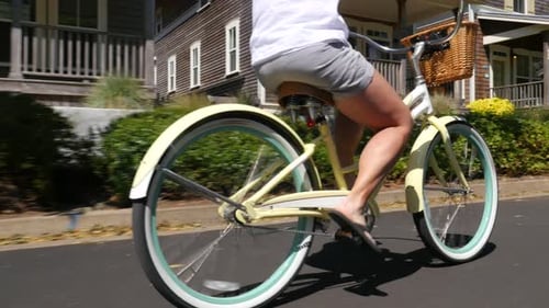 Couple Riding Bicycles Together In Coastal Vacation Community