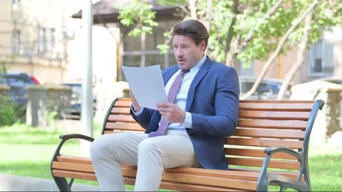 Man on Park Bench Reacts to Bad News
