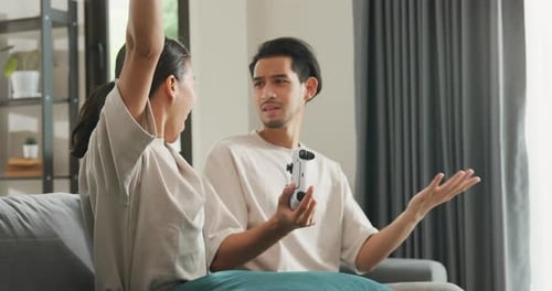 Enthusiastic Couple Playing Video Games at Home