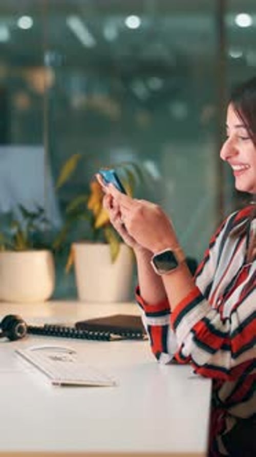 Night, happy woman and typing with phone in office for text message, social media joke