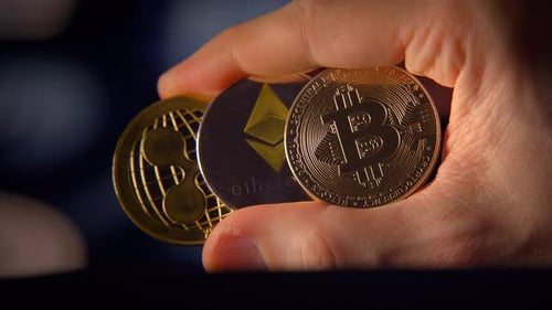 Hand Holding Cryptocurrency Coins Close Up