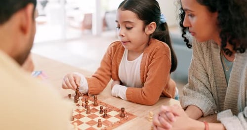 Family Plays Chess Together at Home Indoors