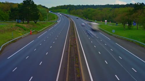 Time Lapse View of Cars Driving Along Roadway in Rush Hour in France Toll Road Near Paris