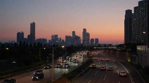 Dusk traffic on Gangbyeonbuk-ro highway with Yeouido and 63 Building skyline