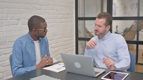 Business People Discussing Project while Sitting in Office