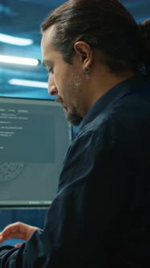 Man Typing on Computer in Brightly Lit Workspace