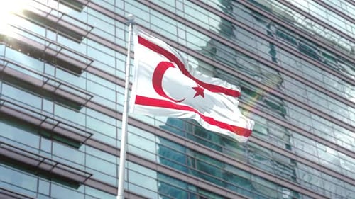 Waving Northern Cyprus Flag in Front of Modern Corporate Building