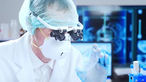 Medical Researcher Examining Petri Dish in Bright Lab