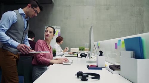 Young business professionals collaborating and talking in a modern office