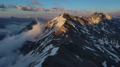 Enticing Snowy Mountains Shrouded in Cloudy Sky Pristine Nature Drone View Enticing Snowy Mountains