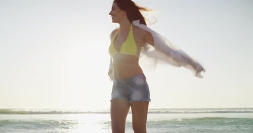 Smile, wind in hair and woman walking at the beach on holiday, vacation