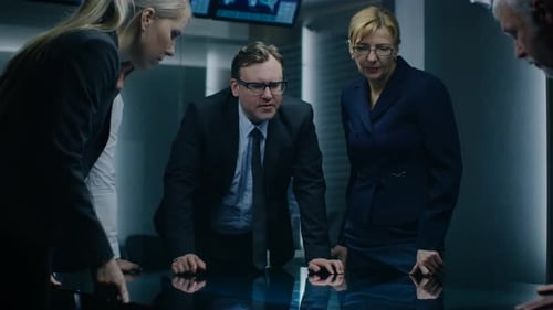 Serious Business Team Discussing Strategy in Dark Room