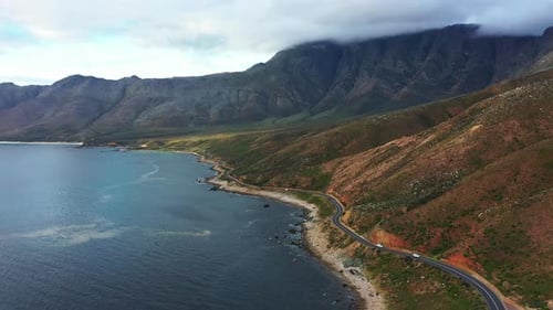 Drone of mountains, ocean and highway in nature for travel, adventure or holiday with eco tourism