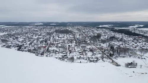 This Image Presents an Aerial View Showcasing a Picturesque Snow Covered Town During Winter Clip