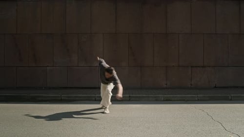 Young Man Breakdancing on City Street During Daytime