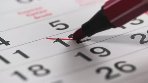 Red Marker Crosses Out Number on Calendar Page