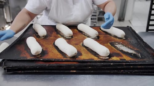 Baker Shaping Dough Rolls On Tray Bakery Production