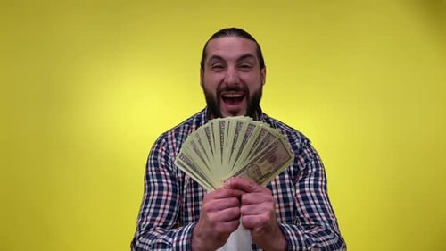 Excited Man Celebrates with a Fan of Money