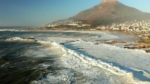 Foamy Ocean Waves Coming Into The Shoreline Of Camps Bay And Bakoven Beaches In Cape Town, South Afr