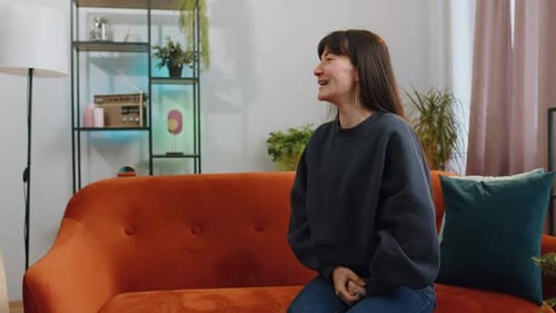 Woman Shares Exciting News With Friend on Sofa