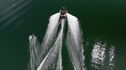 Motorboat Towing Wakeboard Rider On Lake DeFuniak, DeFuniak Springs, Florida. aerial tracking shot