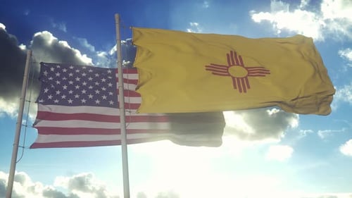 American and New Mexico State Flags Waving in Sunny Blue Sky