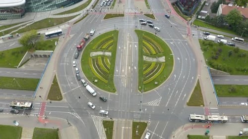 Drone drone rotating shot over Grunwaldzkie roundabout in Krakow, Poland with traffic movement at da