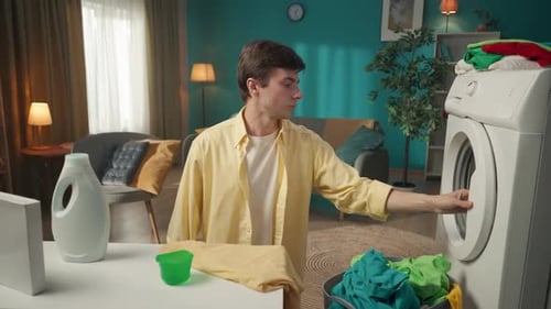 Young Adult Doing Laundry in an Apartment