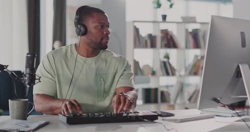 A Young Music Producer is Passionately Creating Unique Tracks Inside a Modern Home Studio