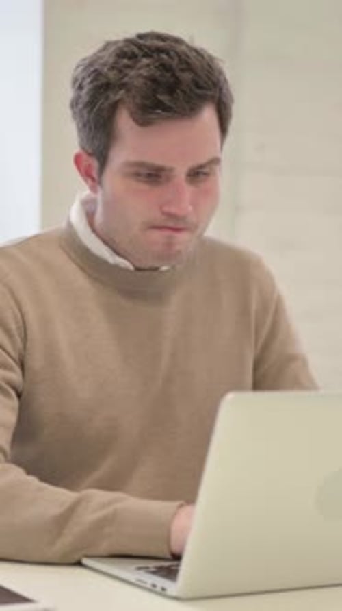 Man Feeling Disappointed While using Laptop, Vertical Video