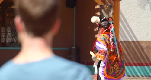 Authentic native american dancer performing traditional rain dance at taos pueblo New Mexico