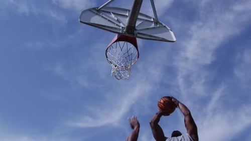 One on One Street Basketball; Low Angle Looking Up at Player Shooting Action