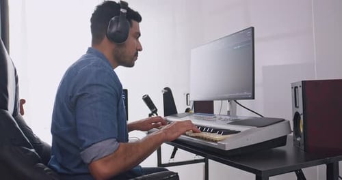Man Playing Keyboard at Home Music Studio