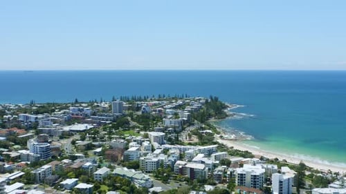 Aerial Drone Above Small Coastal Beachside Town With Headland And Blue Ocean, 4K