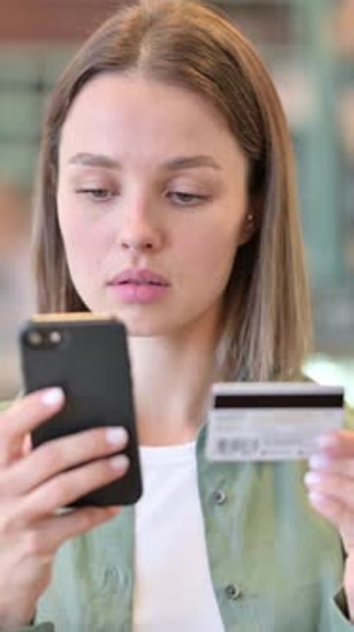 Young Woman Using Smartphone and Credit Card