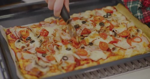 Freshly Baked Pizza Being Sliced With Cutter