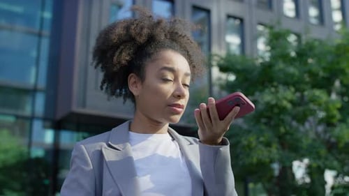 Businesswoman Using Voice Assistant on Street