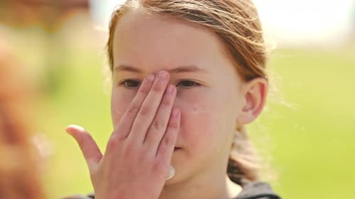 Young Girl Applying Sunscreen on Her Face