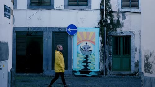 Weathered City Wall with Vibrant Mural and Rain Reflections