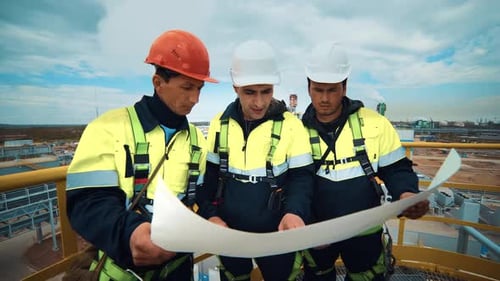 Group of Asian Industrial Engineer Discuss Plan Blueprint Analyzing Chemical Plant Construction