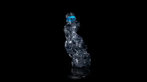 Used Bottle Rotated on Black Background