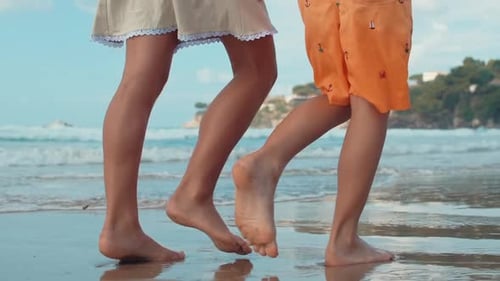 Unrecognizable Children Legs Walking Sea Beach at Summer Vacation. Unknown Teenagers Enjoying