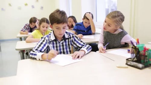Education, Elementary School, Learning And People Concept - Group Of School Kids With Pen And Pap...